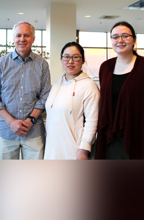 Brian Cunningham is joined by research project members, from the left, Xiaojing Wang and Skye Shepherd, who were co-first authors on the teams’ recently published research. Team members not pictured include: Nantao Li, Congnyu Che, Tingjie Song, Yanyu Xiong, Isabella Rose Palm, Bin Zhao, Manish Kohli, Utkan Demirci, Yi Lu.