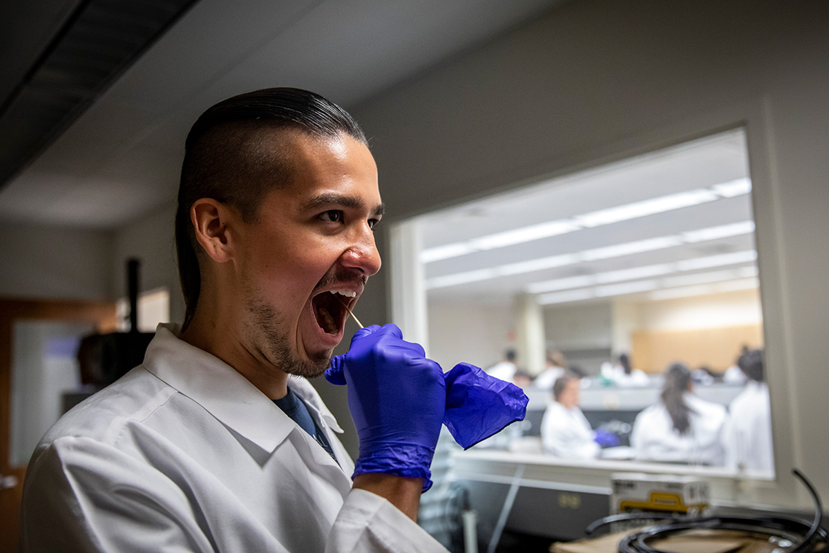 Duke University Ph.D. student Raymond Allen collects a cheek swab for analysis. All DNA samples and data were destroyed upon completion of the exercise.