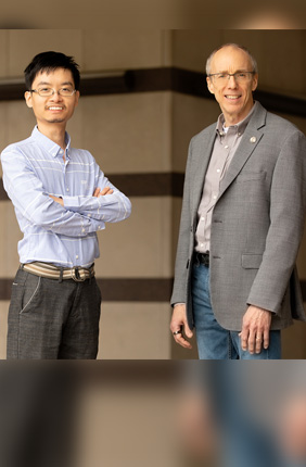 Researchers Yue Liu, left, and Jeffrey Moore are the first to use mechanical force to access unconventional chemical reaction pathways along potential energy surfaces. The new technique could help researchers produce fuels, fertilizers, pharmaceuticals and other materials more efficiently.