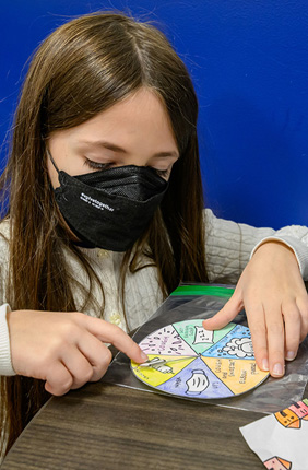 Jessica Brinkworth’s daughter, Jordan Brinkworth-Sykes, age 10, plays the game “Stop the Pathogens!” created by U. of I. student Claire von Ebers in the evolutionary immunology class.