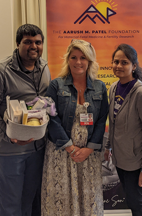 Mitul Patel (left) and Aditi Patel (right) with a representative from Community Hospital North in Indianapolis (center) at last year's golf outing
