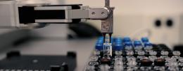 A robot positions "bloccs" for assembly via automated, iterative carbon-carbon bond formation. Credit: Molecule Maker Lab