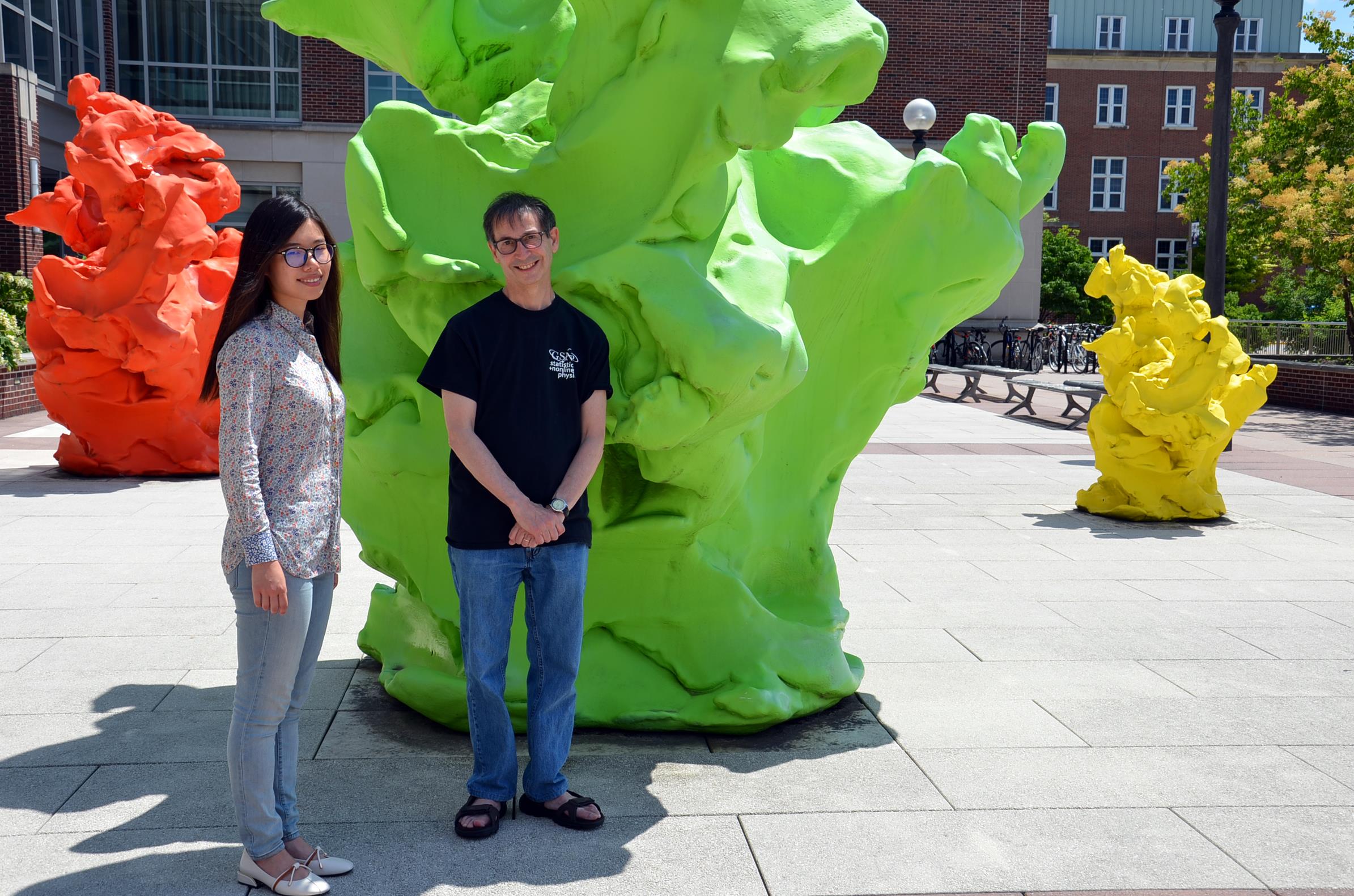 Professor Nigel Goldenfeld (right) and his graduate student Minhui Zhu pose outside the Institute for Genomic Biology on the University of Illinois at Urbana-Champaign Campus. Goldenfeld and Zhu elucidated the experimental observations using a theory borrowed from the field of soft condensed matter, establishing that charge order stripe formation in cuprate superconductors adhere to a universal scaling law, akin to pattern formation in liquids and polymers. Photo by Siv Schwink, Illinois Physics