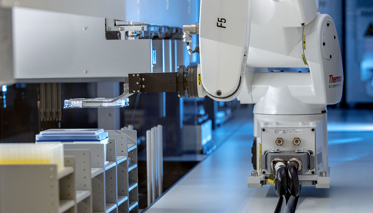iBioFAB is a synthetic biology foundry that features a 6-degree-freedom articulated robotic arm that travels along a 5-meter-long track to transfer microplates among more than 20 instruments installed on the platform.